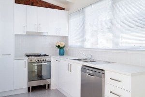 Modern white kitchen with PVC window blinds