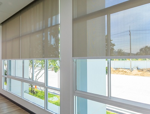 Roller blinds on window used for sun and heat protection