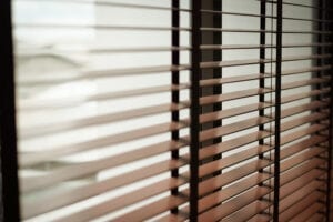 Brown shutters on an indoor window.